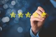 Review, increase rating or ranking, evaluation and classification concept. Businessman draw five yellow star to increase rating of his company. Bokeh in background.