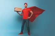 Courier acts like a superhero. Concept of success and guarantee on shipment. Studio cyan background