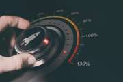 Hand turning a button with a rocket icon to the maximum acceleration. Concept of career accelerationComposite between an image and a 3D background.