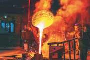Liquid iron molten metal pouring in container, industrial metallurgical factory, foundry cast, heavy industry background.