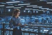 Data Center Female It Specialist Using Laptop. Server Farm Cloud Computing and Cyber Security Maintenance Administrator Working on Computer. Information Technology Professional.
