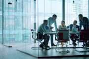 Group of business people working with technology at a meeting in a conference room in office