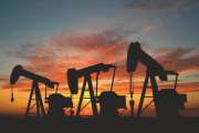 Three pumps over orange sky