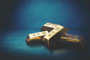 Wealth concept with pile of gold bars or ingots on a dark background - 3D illustration