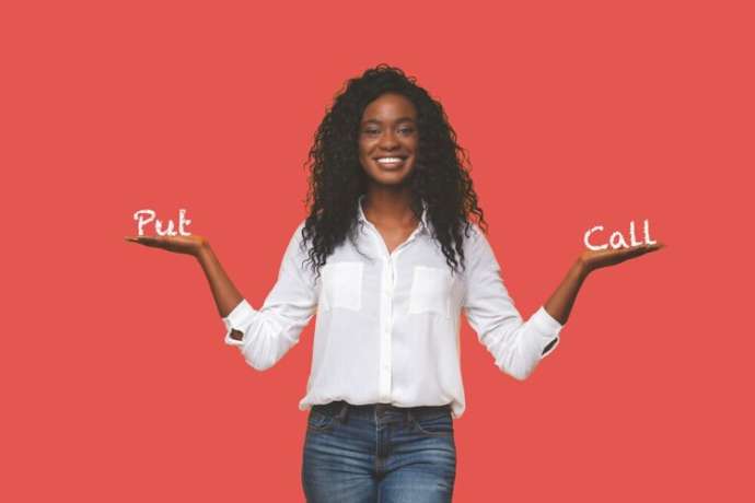 Make right choice. Positive african girl comparing variants, making scales with his empty hands, yellow studio background, free space