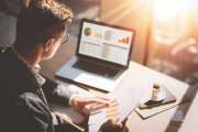 Finance market analyst in eyeglasses working