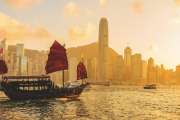 Chinese wooden red sails ship in Hong Kong Victoria harbor at sunset time