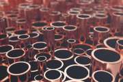 Heap of shiny copper pipes with selective focus effect. 3d rendering.