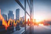 A modern cityscape at sunset, showcasing financial growth and investment with a stunning visual representation of market data.
