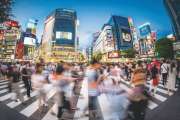 Fisheye view of crowds of people at the famous Shibuya Crossing.