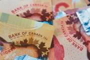 canadian money in a pocket of a blue jeans