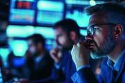 Team of investors works late at night in an office, analyzing charts and data on computer screens, discussing strategies for success in the financial market