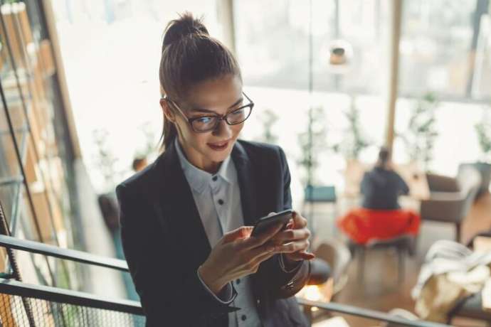 Top view of young businesswoman using technology.