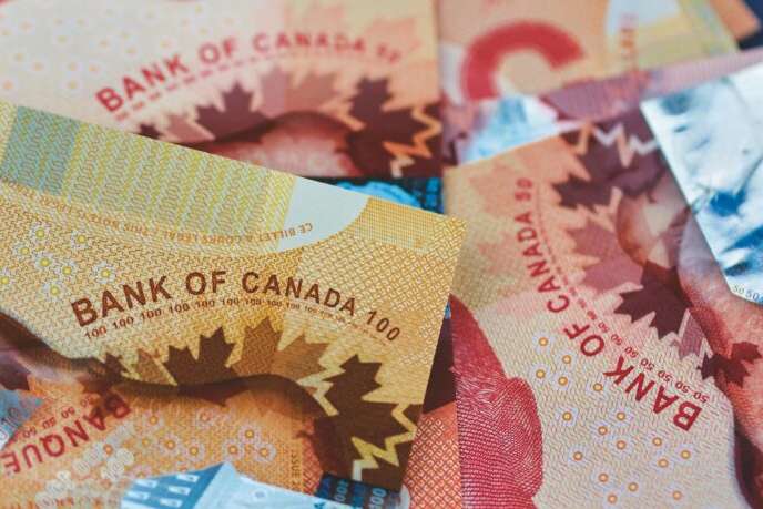 canadian money in a pocket of a blue jeans