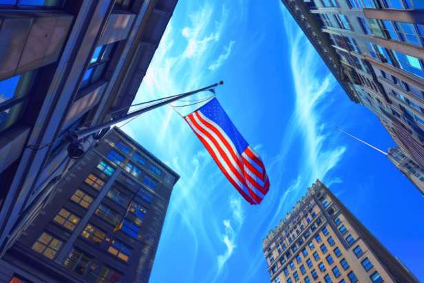 Usa flag fluttering in the wind over a street scene