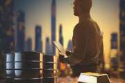 Barrels of oil with charts and graphs of stock market as a concept of raw material. Financial world crisis concept. Up of oil price, market grow up.