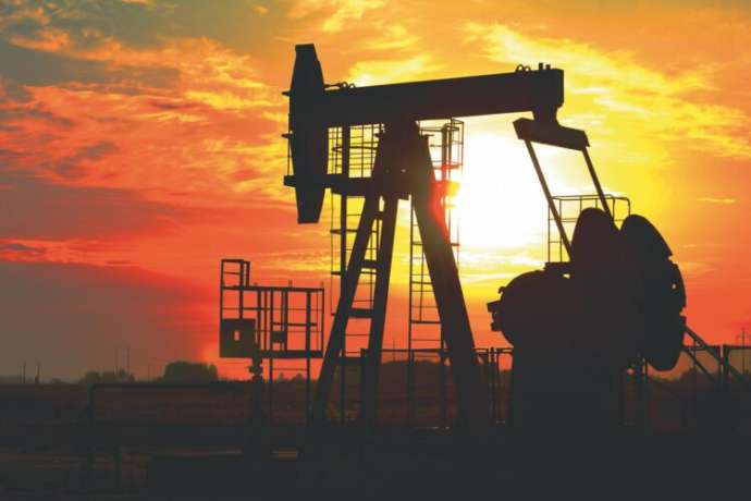 Oil drilling derricks at desert oilfield for fossil fuels output and crude oil production from the ground. Oil drill rig and pump jack.