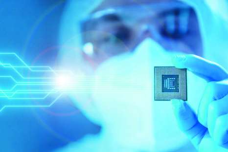 Close-up of Professional Scientist Holding a Modern Microprocessor Chip in his Hand. The Concept of Scientific Laboratory, Research and Development of Microelectronics and Processors. Manufacturing Worker uses Computer Technology and Equipment.
