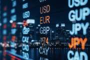 A city skyline illuminated at night, displaying a digital currency exchange board showing various currency rates, including USD, EUR, and JPY.