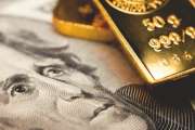 Close-up of a 20-dollar banknote (figuring president Jackson) and a gold bullion