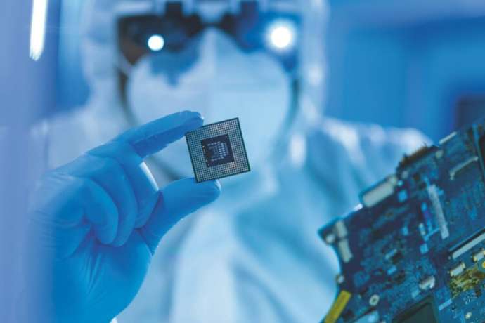 Professional African-American scientist works in a modern scientific laboratory for the research and development of microelectronics and processors. Microprocessor manufacturing worker uses computer technology and equipment.