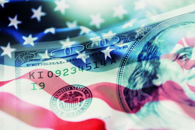 USA flag and American dollars. American flag blowing in the  wind and 100 dollars banknotes in the background.
