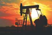 Oil drilling derricks at desert oilfield for fossil fuels output and crude oil production from the ground. Oil drill rig and pump jack.